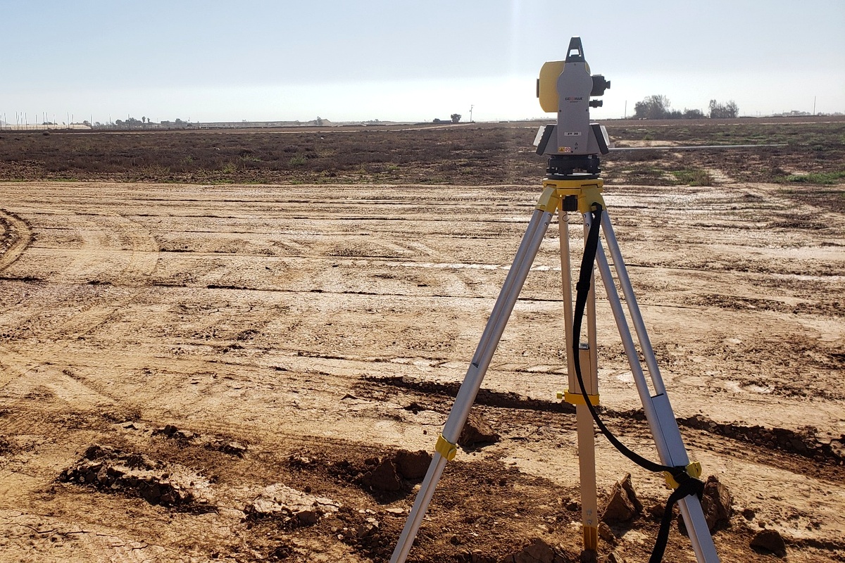 ACACIA surveyor operating a total station on land in the San Quintín valley