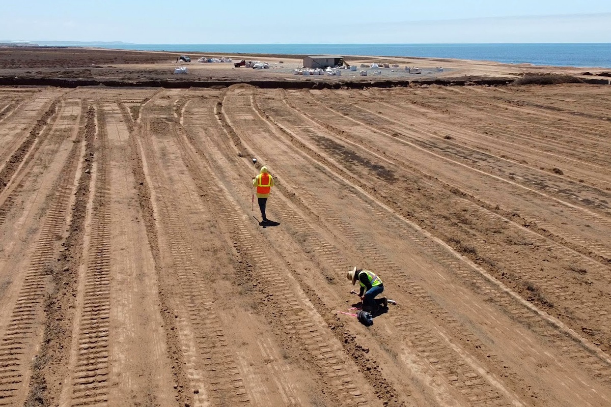 Aerial view of an ACACIA crew surveying a coastal property