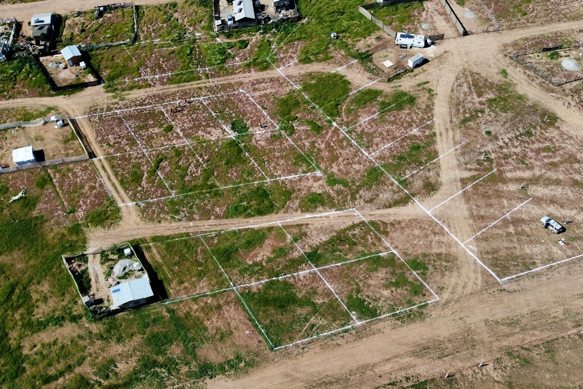 Aerial view of a subdivision with staked lot boundaries