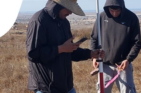 Dos topógrafos tomando datos con bastón GNSS en campo